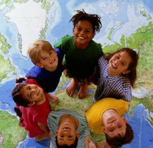 Cover photo of the Building the Legacy training curriculum, showing six children standing atop the world, heads tilted back, grinning.
