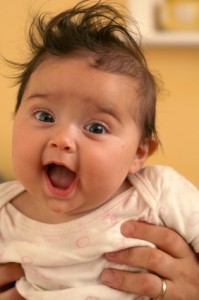 excited, little, wild-haired baby