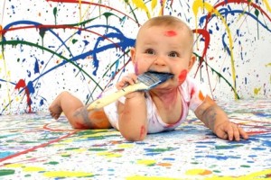 An adorable baby with paint on its face