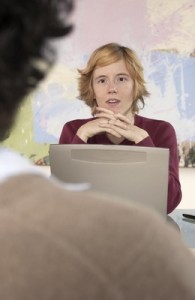 Photo of a young woman wit a disability in a job interview.