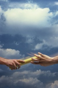 Closeup of the "handoff" of the baton in a relay race.