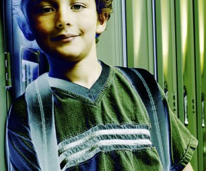 Student leaning against his locker.