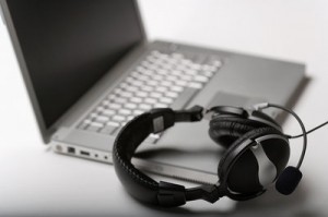Photo of a laptop computer and a pair of headphones.