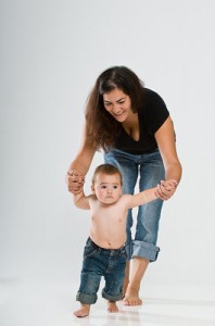 An early interventionist helps a baby with his walking.