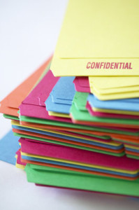 Picture of a stack of folders marked "Confidential."