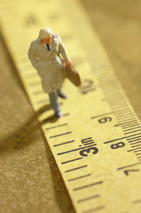 Man walking along a measuring tape.