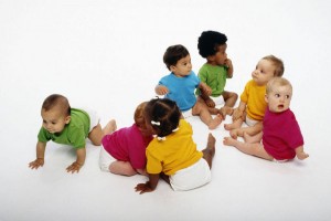 A gaggle of babies in brightly colored shirts.