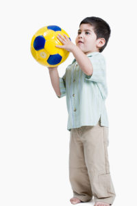 Preschooler playing with a ball