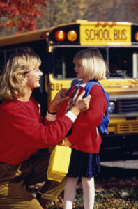 Mom and daughter waiting for the school bus to arrive