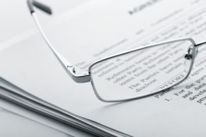 Closeup of glasses atop a set of papers