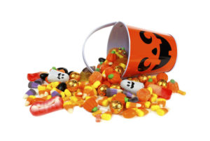 A Halloween bucket spilling out candies and treats