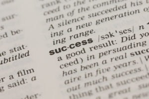 close-up on definition of the word success in the dictionary
