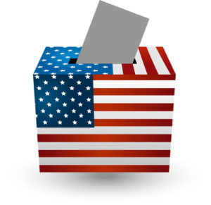 A box decorated with the US flag and a ballot being dropped into its slot