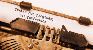 Strive for progress, not perfection - Written on an old typewriter, vintage