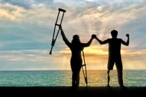 A young man with limb loss faces a gorgeous sky and sea