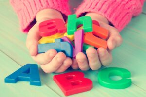 Child tumbles letters out of her hands