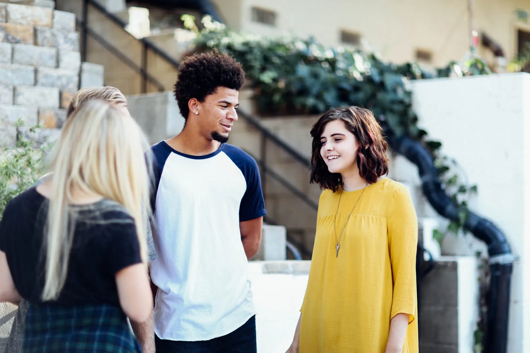 young college students standing outside talking