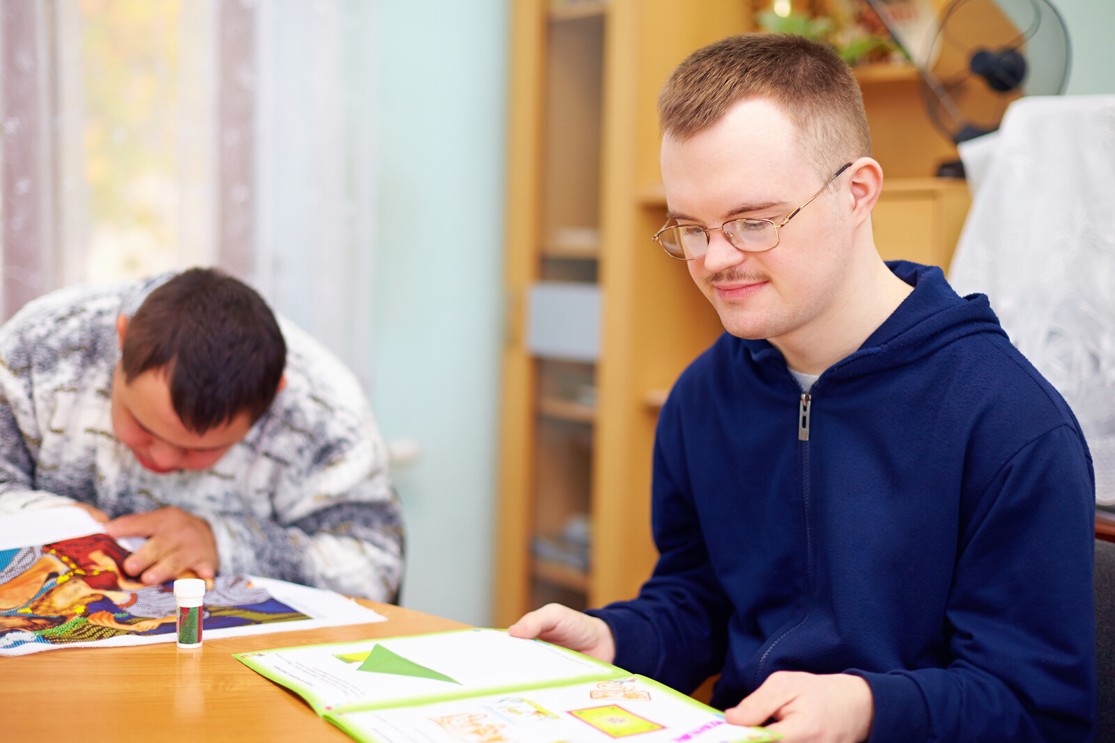 young disabled man reading young disabled man reading