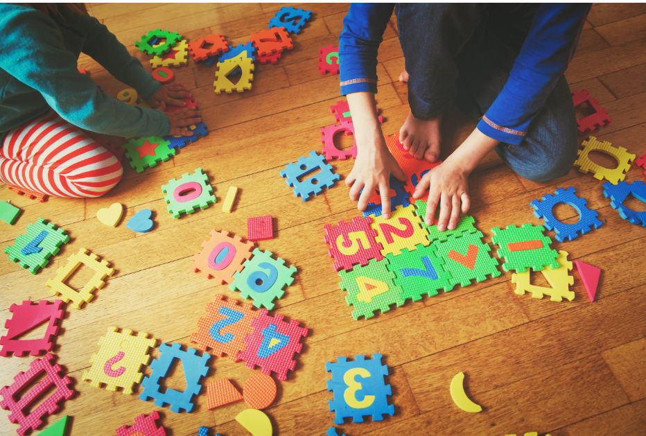 KidsBuildingPuzzle Kids putting together a puzzle.