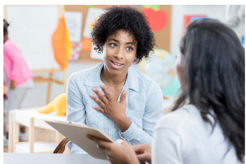 Parent and teacher talking - Copy Parent and teacher talking at a meeting.