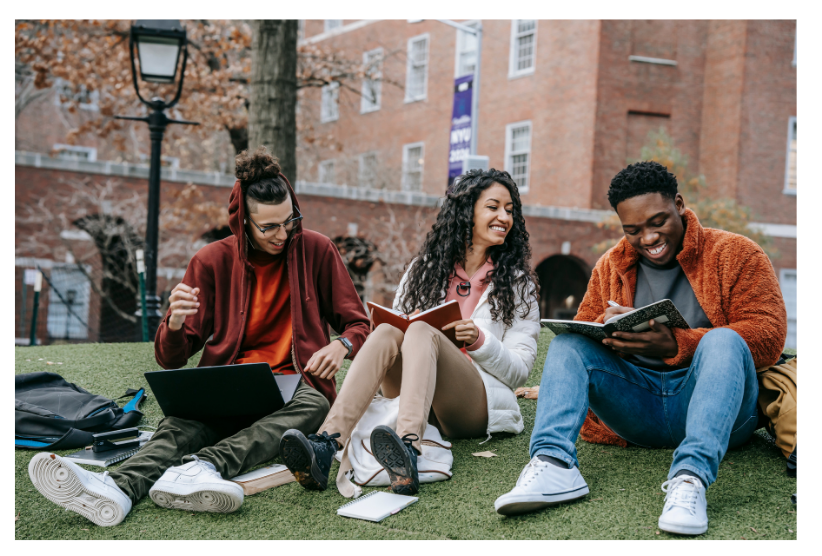 Young Adults studying together outside in a city park. 