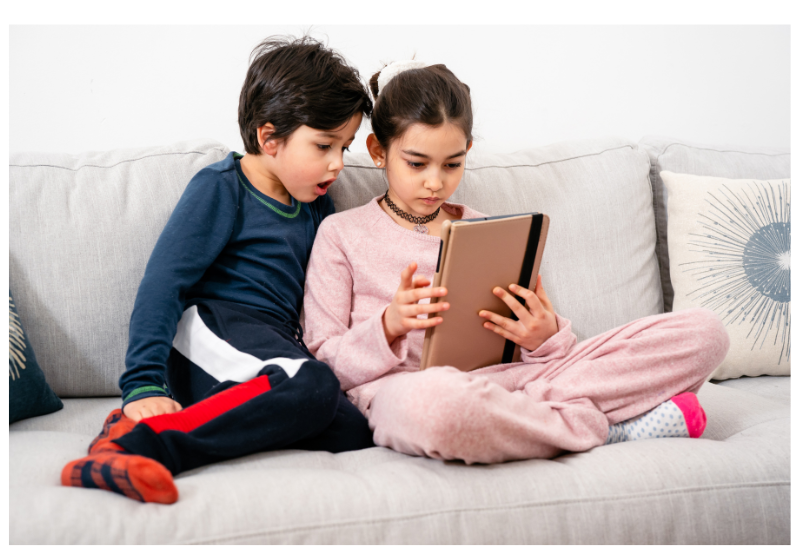 Children looking at an iPad. 