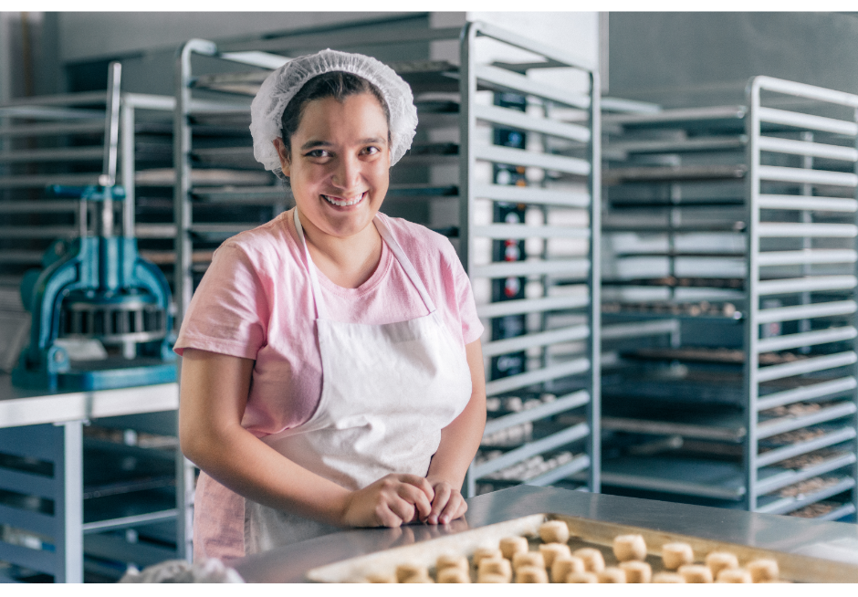 Young adult with a disability baking for her job. 