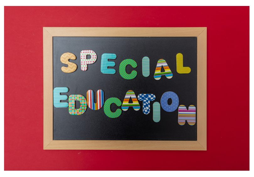 Picture frame with different color letters spelling Special Education Inside.