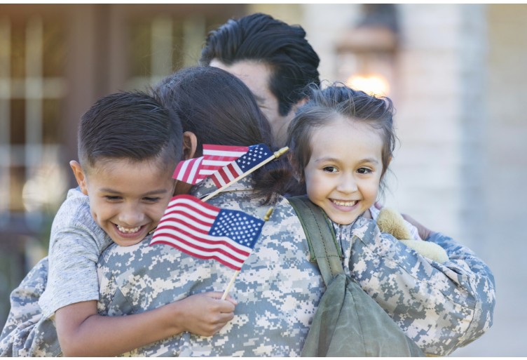 Mom in military clothing hugging her children and husband. 