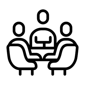 Image of 3 figures sitting around a table.